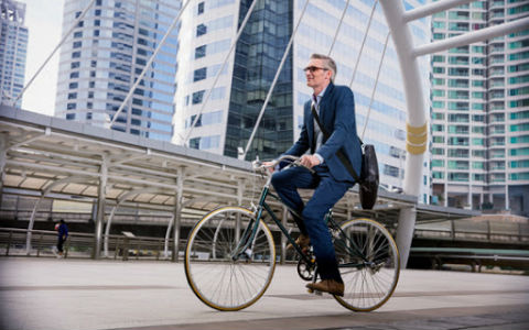 Man on bike wearing glasses with Crizal Sapphire UV lens protection